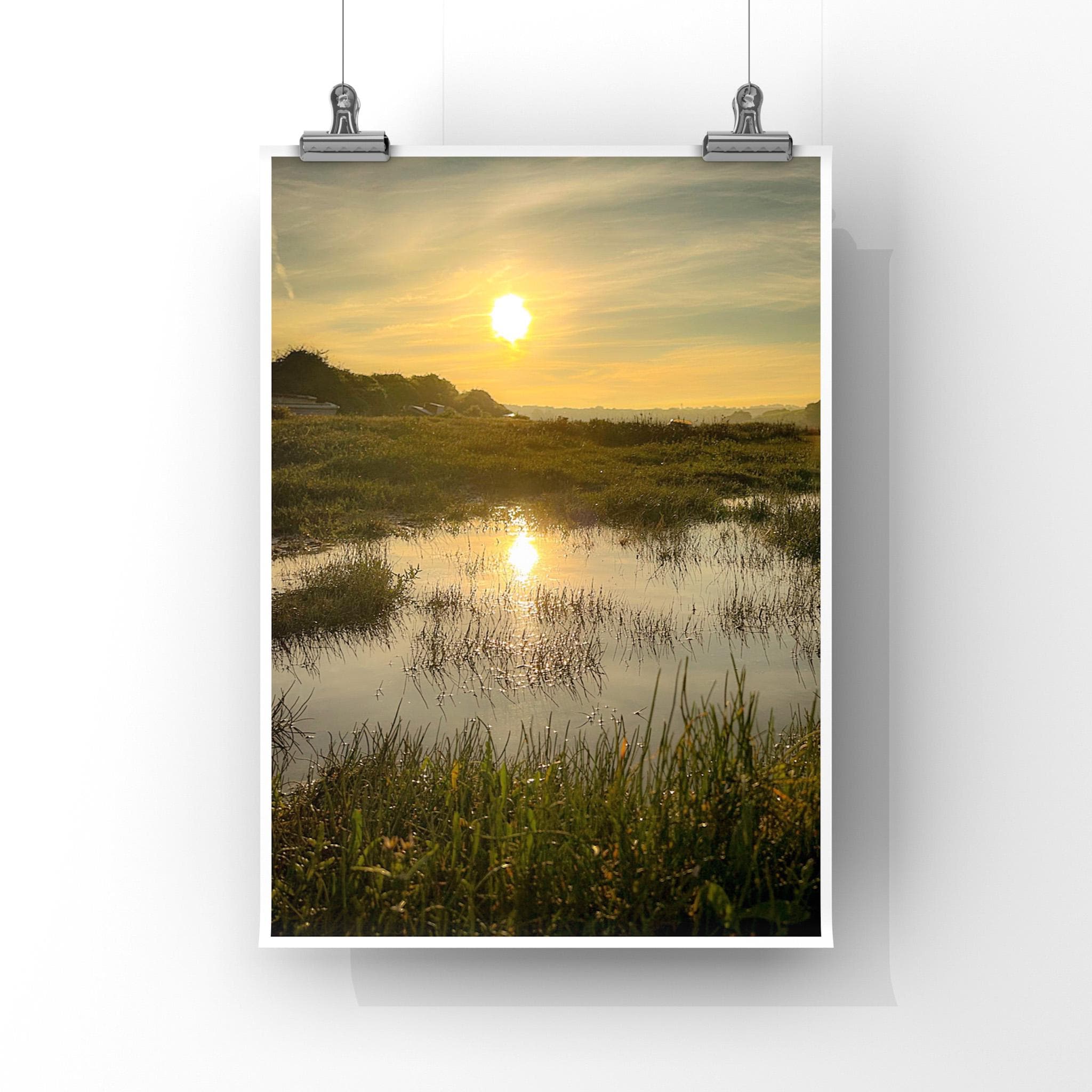 Poster of a reflected sunrise over a marshy field, displayed on a white background.