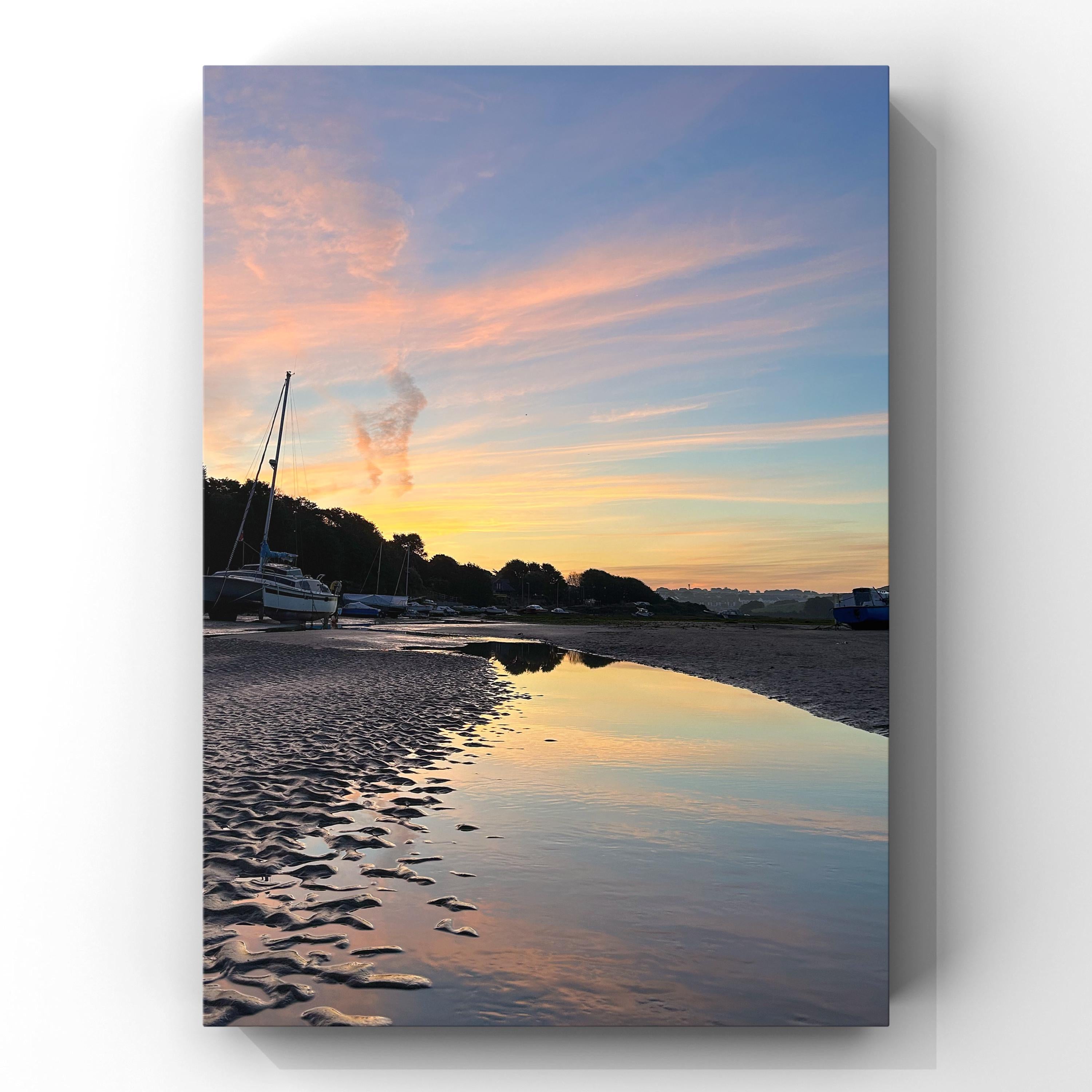 Estuary landscape with a pastel sunset over water and trees, on a white background