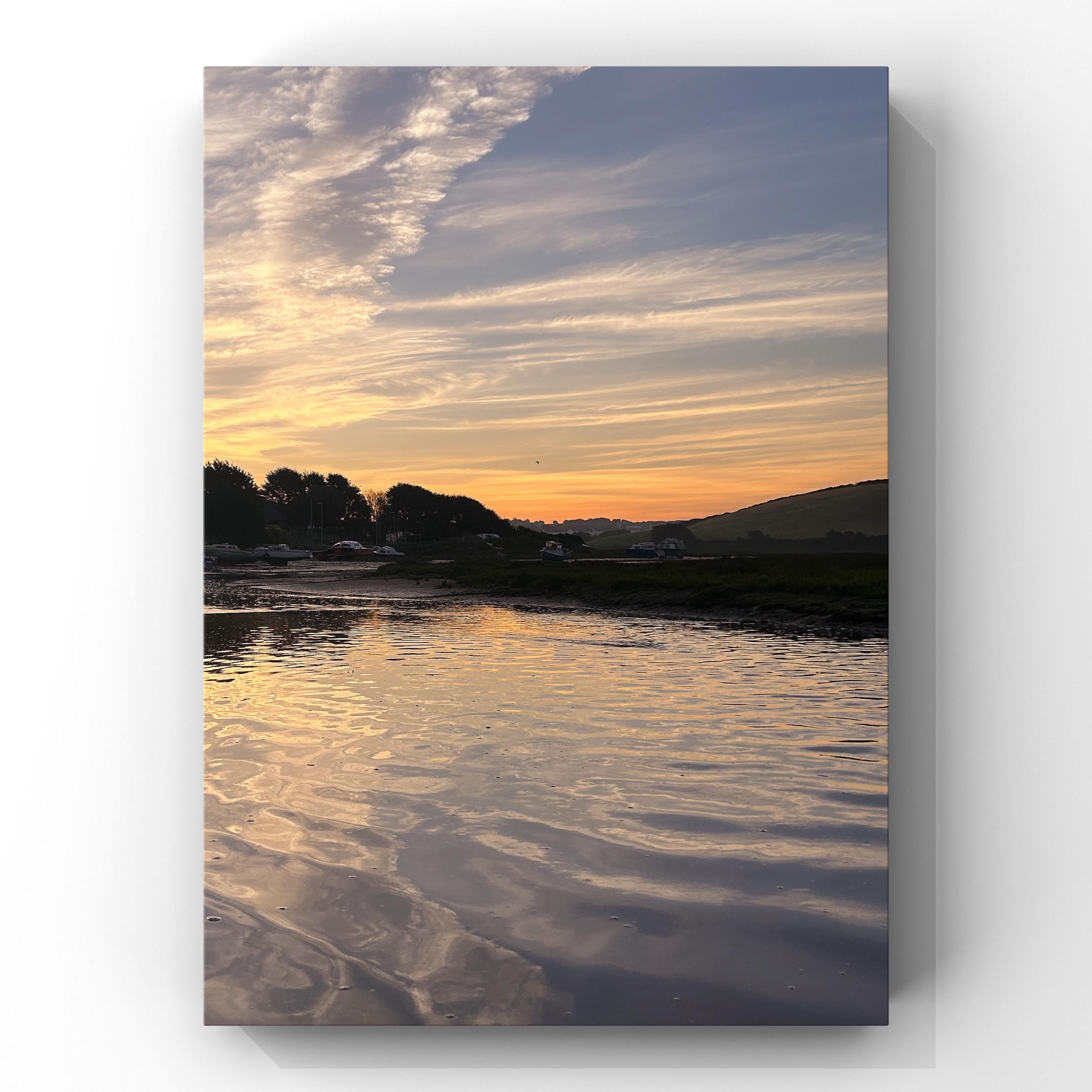 River landscape with water reflecting a colorful sky at sunrise