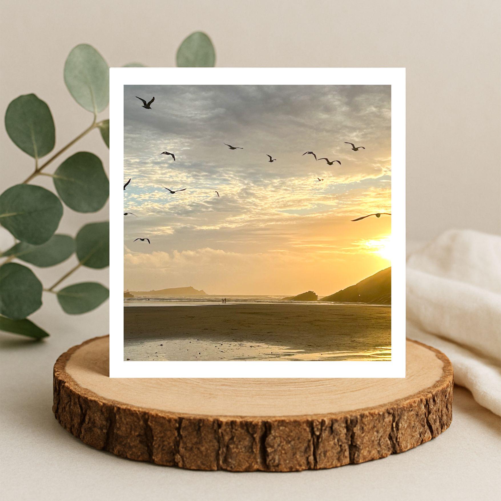 Framed beach sunset with birds greetings card on a wooden log slice