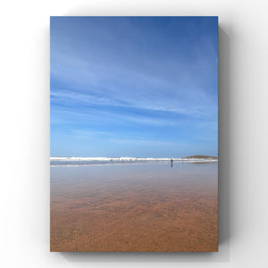 Beach scene with clear blue sky and calm water