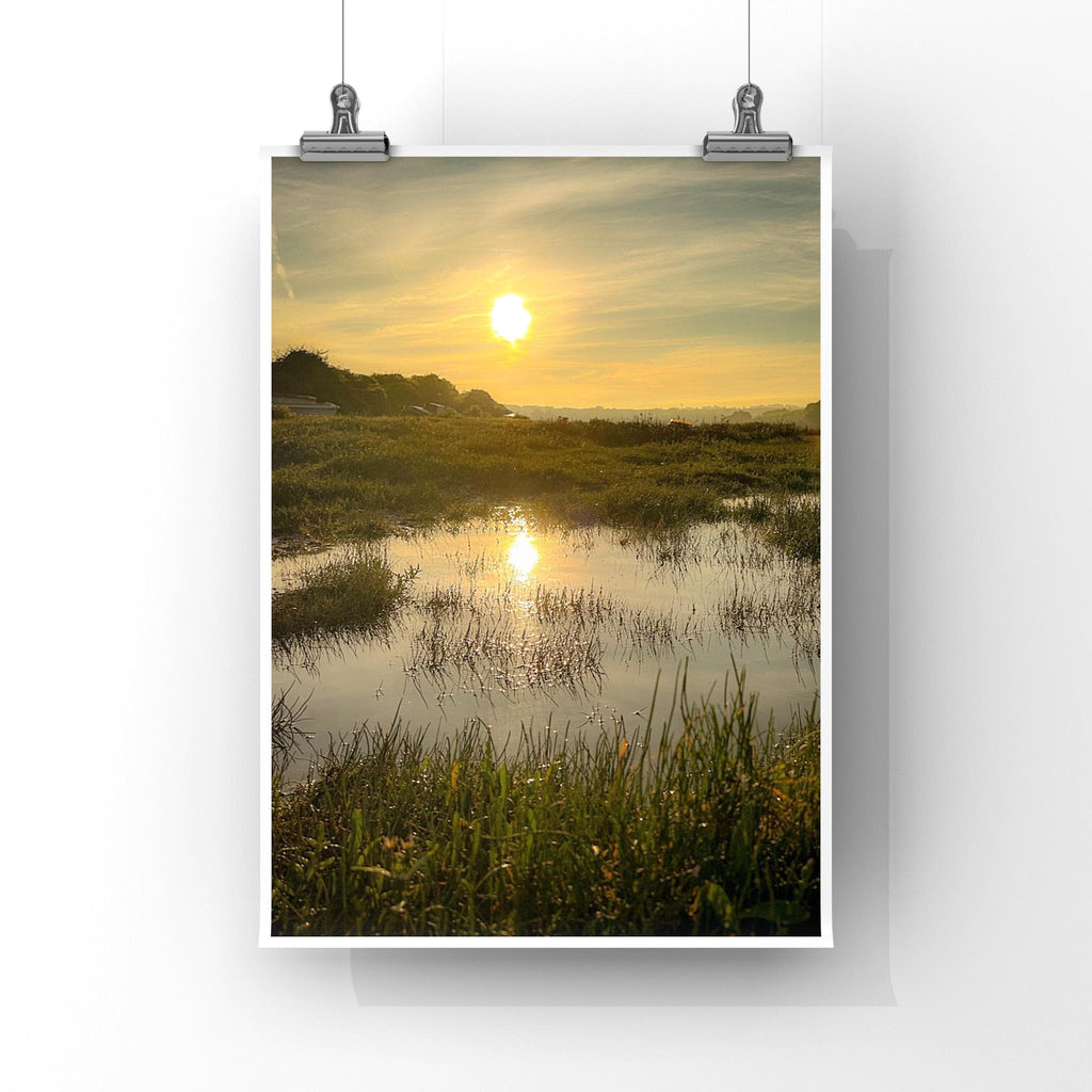 Poster of a reflected sunrise over a marshy field, displayed on a white background.