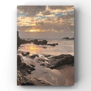 Portrait print of a sunset over a rocky beach with water reflections.